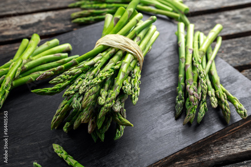 Fresh raw green Asparagus on wooden chopping board