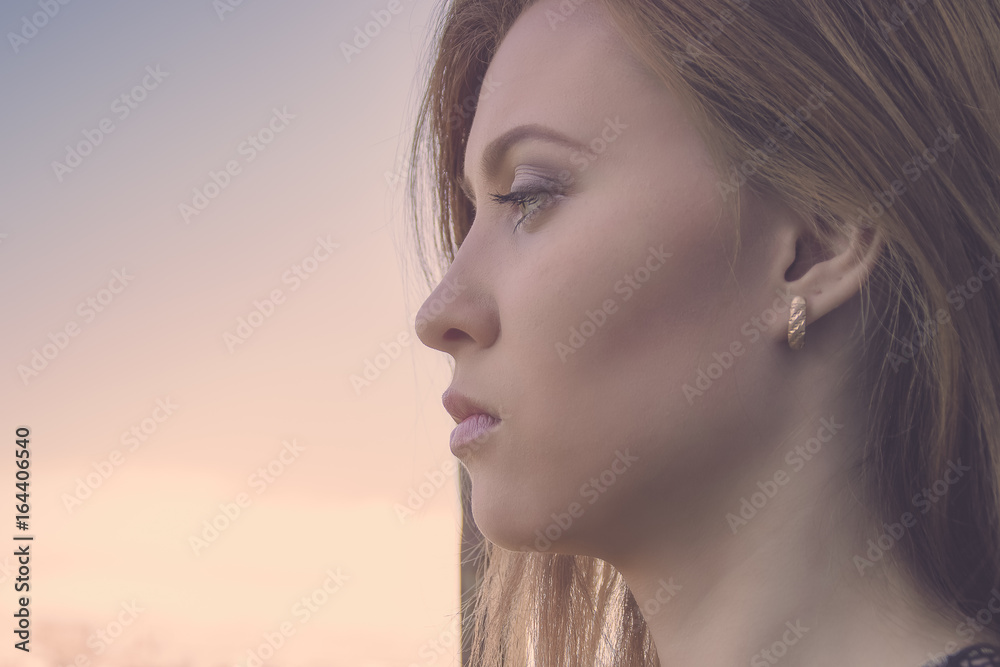 Half face portrait of beautiful young woman at the sunset or sunrise. Washed effect Half face portrait of beautiful young woman at the sunset or sunrise. Washed effect