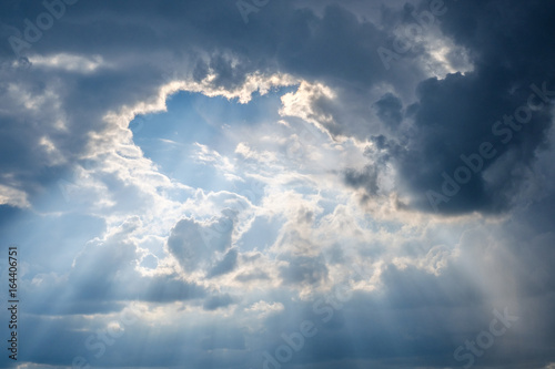 Fototapeta Naklejka Na Ścianę i Meble -  sun rays shining through  thick cloud sky