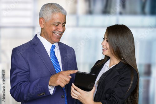 Businesswoman At Work With Senior Client