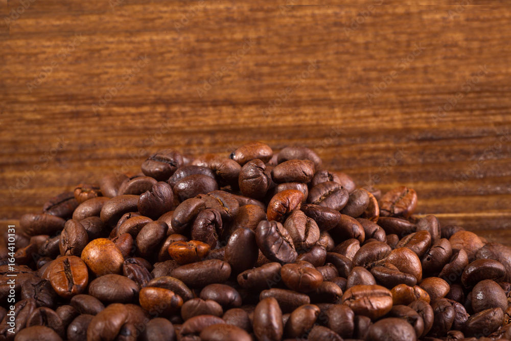 Fototapeta premium Coffee beans on wood background