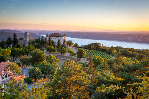 View of Aiguines village with charming chateau and church overlooking Lac de Sainte Croix Lake, Var department, Provence, France