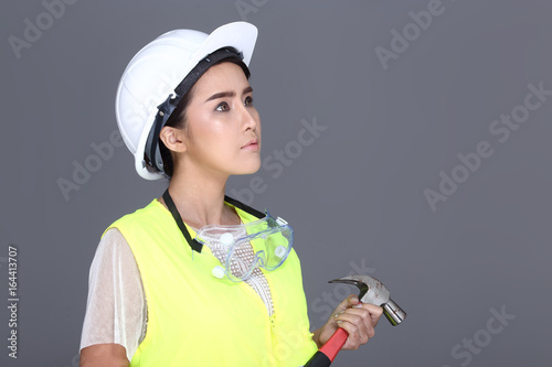 Asian Architect Engineer woman in white hard hat, safety vast, protector glasses goggle