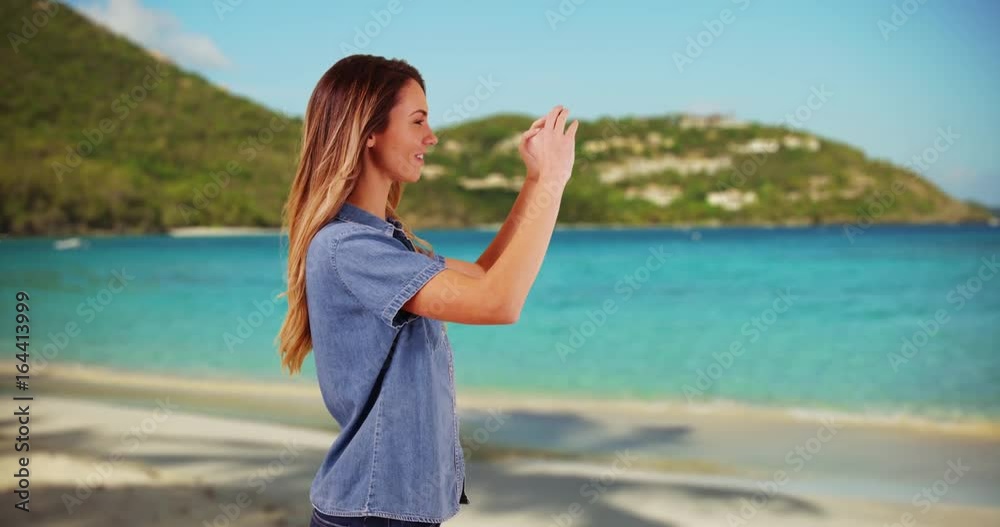 Profile of attractive millennial girl taking a picture with cellphone on the beach. Profile of young Caucasian woman photographing the ocean view while on vacation in summer. 4k Profile of attractive millennial girl taking a picture with cellphone on the beach. Profile of young Caucasian woman photographing the ocean view while on vacation in summer. 4k