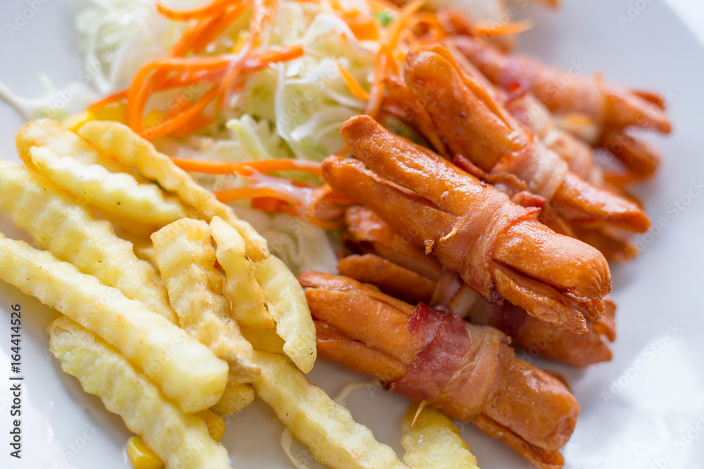 Sausages wrapped with bacon Sausages wrapped with bacon