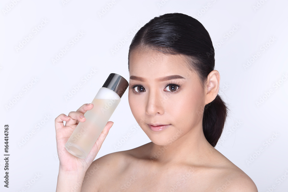 Young smiling female holding a white blank round jar bottle of Cosmetic skin care package product