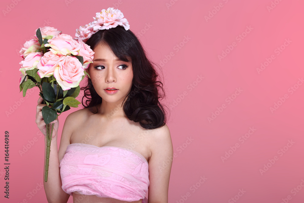 Beautiful Asian Woman black hair with flora crowd, holding bouquet artificial rose over chest Beautiful Asian Woman black hair with flora crowd, holding bouquet artificial rose over chest
