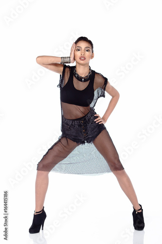 Full Length Tan Skin Asian Woman in sport bra, short jean and black net dress and high heels
