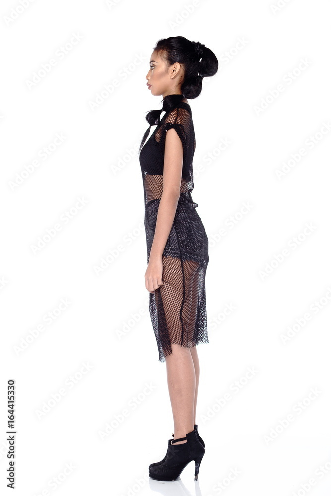 Full Length Tan Skin Asian Woman in sport bra, short jean and black net dress and high heels Full Length Tan Skin Asian Woman in sport bra, short jean and black net dress and high heels