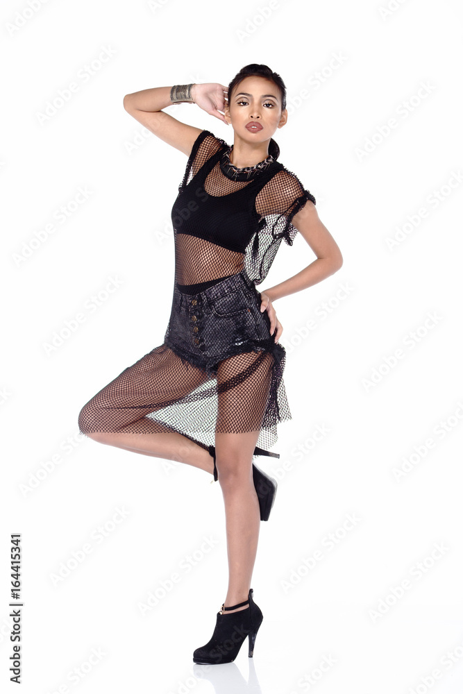 Full Length Tan Skin Asian Woman in sport bra, short jean and black net dress and high heels Full Length Tan Skin Asian Woman in sport bra, short jean and black net dress and high heels