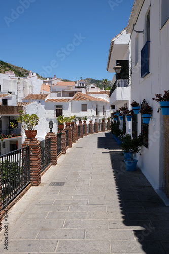MIJAS, ANDALUCIA/SPAIN - JULY 3 : View of Brick Piers and Blue Flower Pots in Mijas   Andalucía Spain on July 3, 2017 © philipbird123