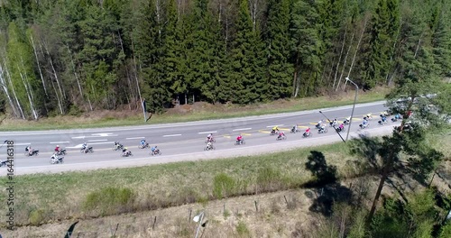 Bicycle race, Cinema 4k aerial rising view of a group of cyclists, racing on a cycle competition event, on a summer day, just outside Nuuksio national park, in Espoo, Finland