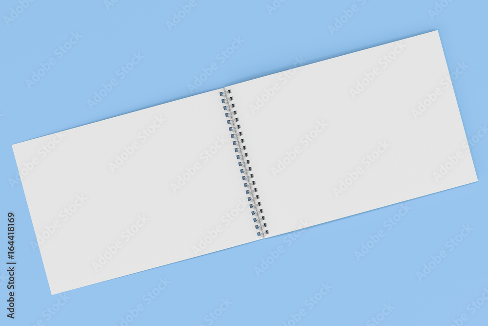Open blank white notebook with metal spiral bound on blue background Open blank white notebook with metal spiral bound on blue background