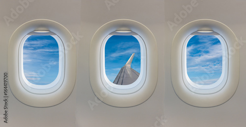 window on airplane with blue sky.