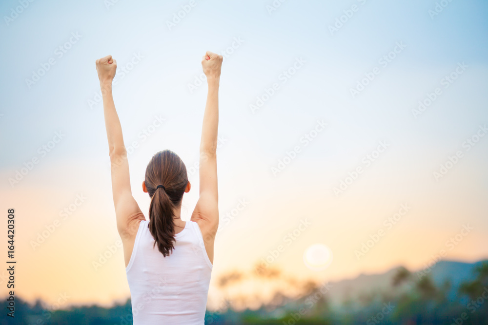 People winning achievement concept. Young woman with fist in the air celebrating success and happiness. People winning achievement concept. Young woman with fist in the air celebrating success and happiness.