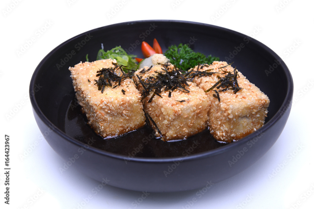 Japanese Agedashi Tofu or Crispy deep fried Tofu served in tentsuyu broth isolated on white background (clipping path) Japanese Agedashi Tofu or Crispy deep fried Tofu served in tentsuyu broth isolated on white background (clipping path)