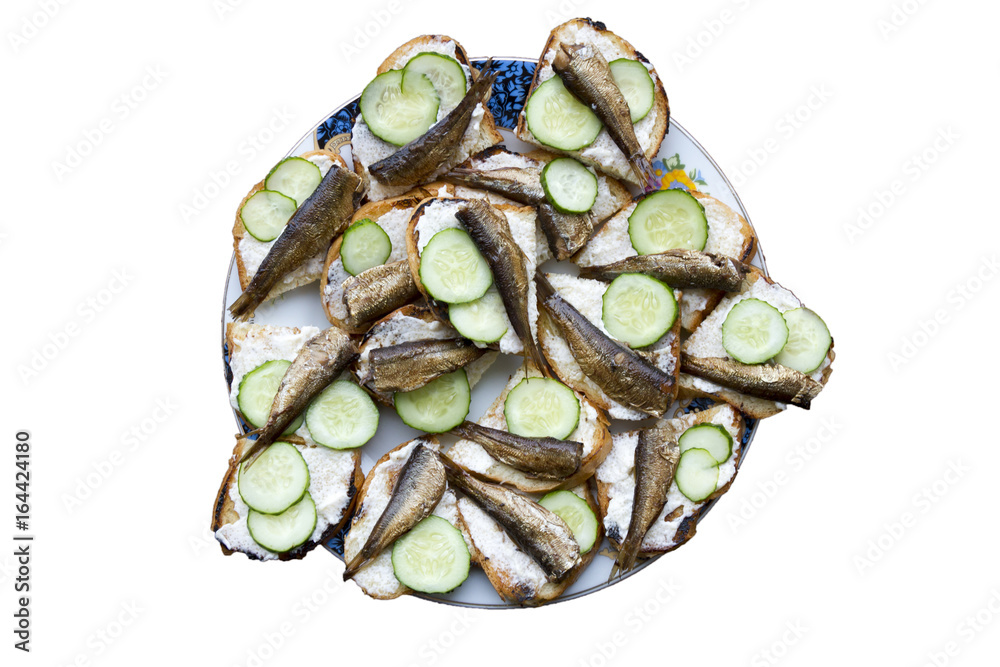 A large plate of sandwiches with sprats On white background A large plate of sandwiches with sprats On white background