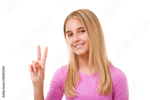 Picture of lovely young girl showing victory or peace sign.Isolated
