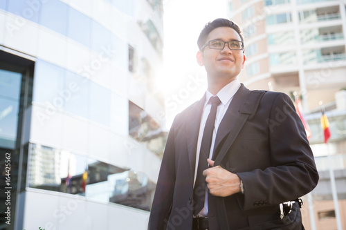 Young asian businessman outdoors