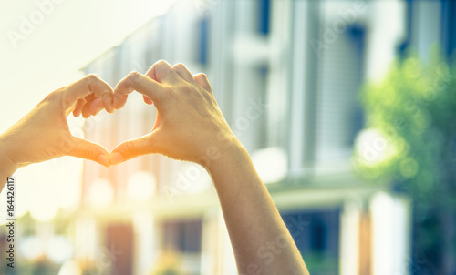 hand touch together to make heart symbol .