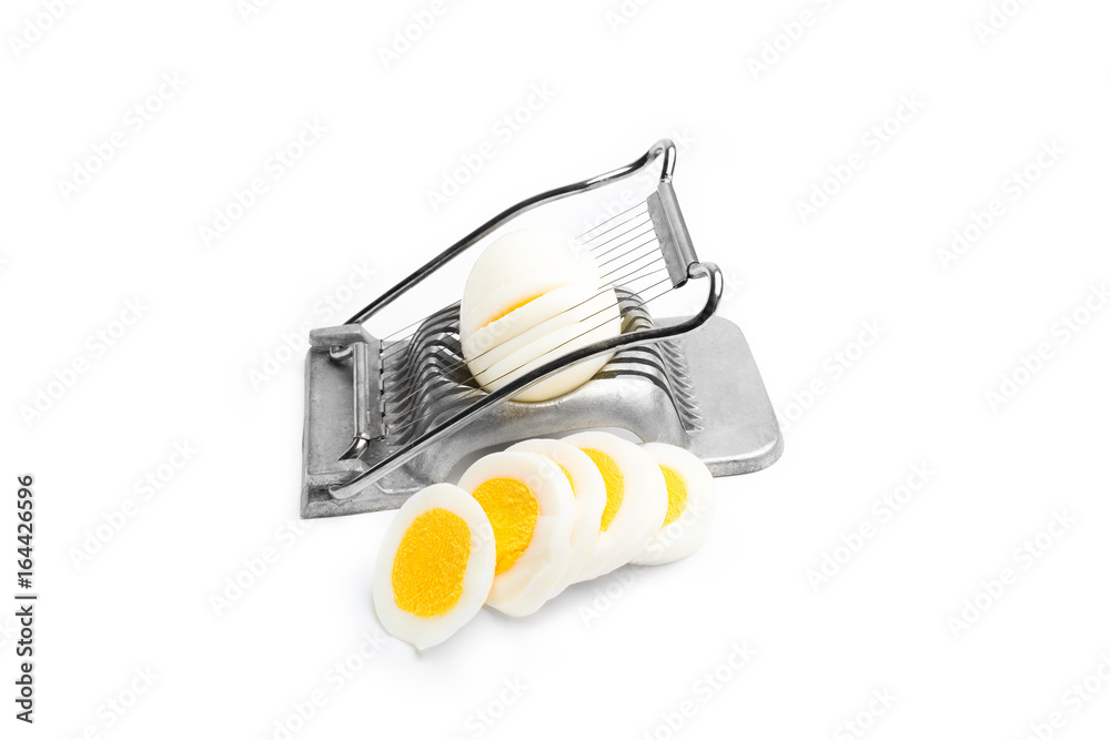 Retro egg slicer and eggs on white background Retro egg slicer and eggs on white background