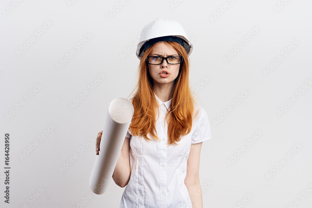 Beautiful young woman on white isolated background holds blueprints, engineer Beautiful young woman on white isolated background holds blueprints, engineer