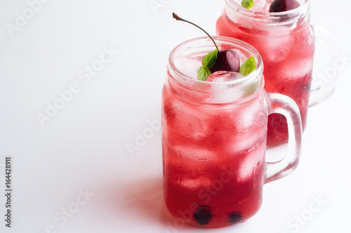 Wallpaper Mural Two glass mugs with a red drink and ice on a white background. Torontodigital.ca