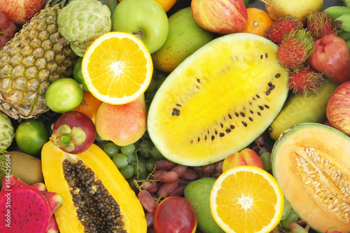 Many tropical fruits as background