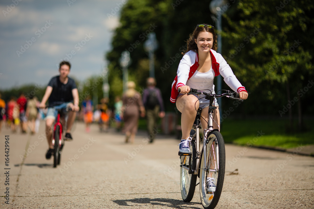 Urban bicycle - teenage girl and boy cycling