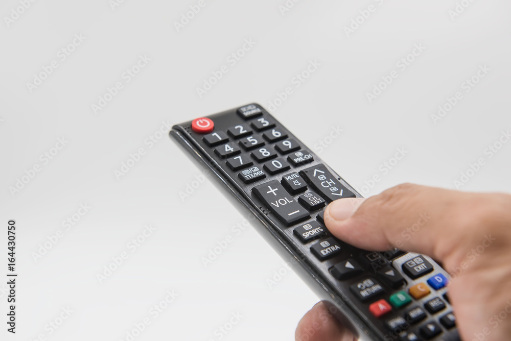 black remote control in hand on white background . black remote control in hand on white background .