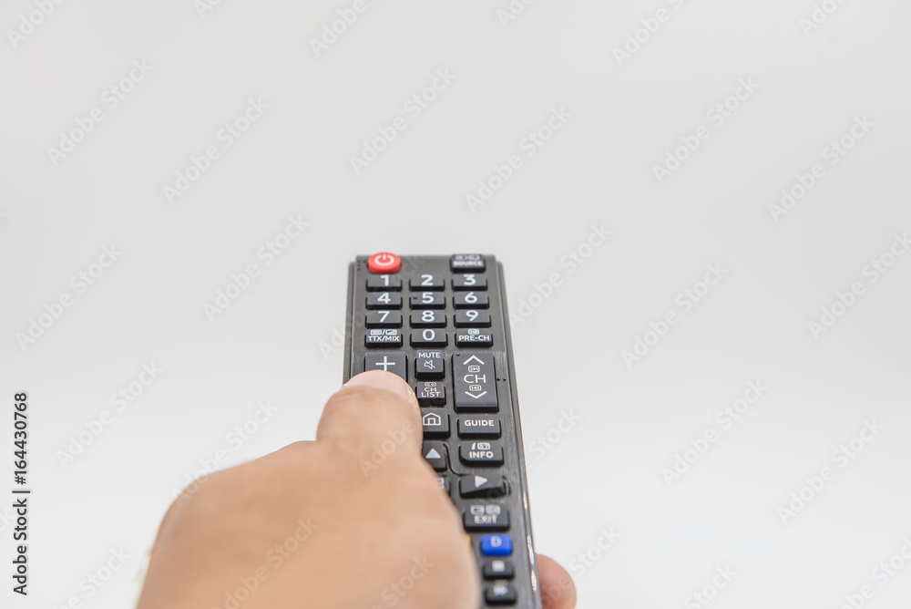 black remote control in hand on white background . black remote control in hand on white background .