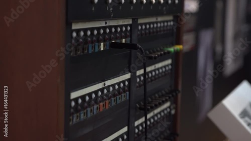 Close-up of female hand using 30-line teleprinter switchboard. Old network service