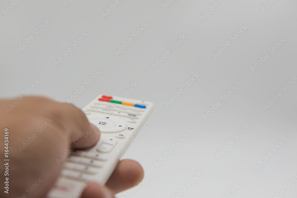 white remote control in hand on white background . white remote control in hand on white background .