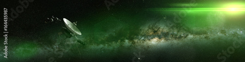 Voyager spacecraft in front of the Milky Way galaxy and a bright green star in deep space