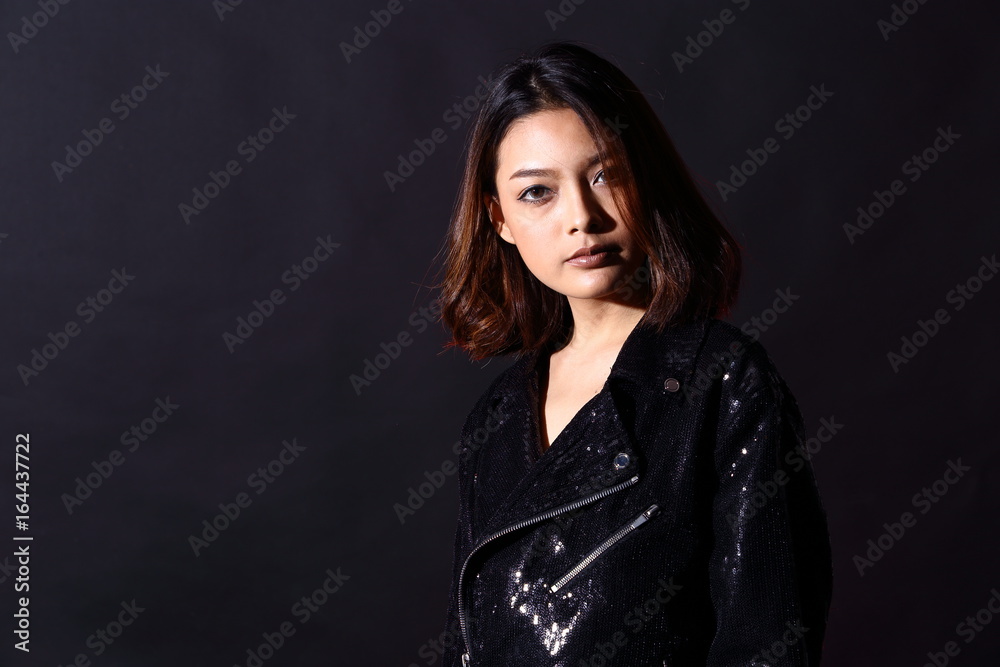 low key portrait of slim healthy woman in black background with fog smoke and light from back low key portrait of slim healthy woman in black background with fog smoke and light from back