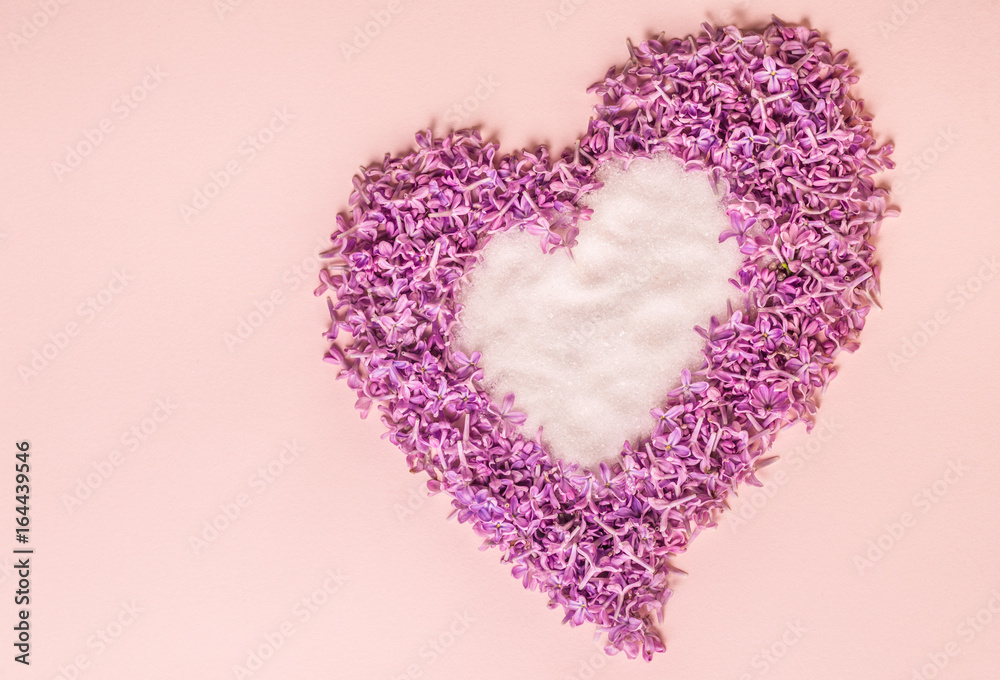 Heart made of sugar and flowers of lilac. Background for a site design or landing page about food, health, flowers and spring. Layout on a pink background. A place for your inscriptions.