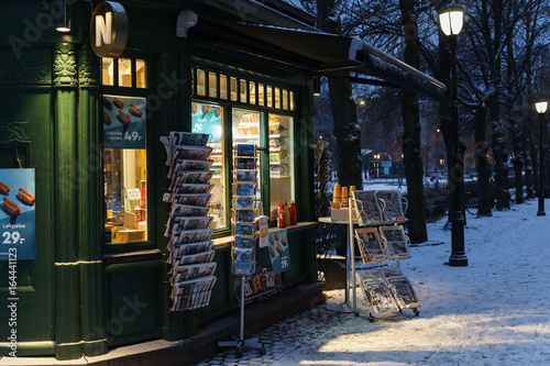 Green kiosk in winter street,  newspaper stand photo