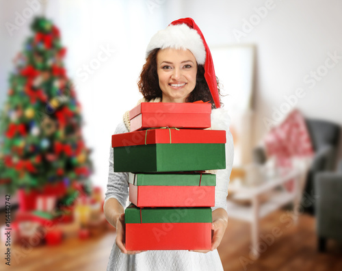 Happy woman holding Christm...