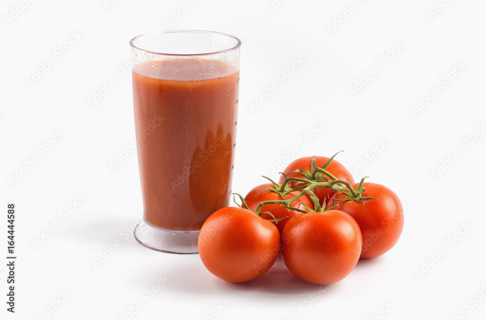 Tomato juice in glass and tomatoes