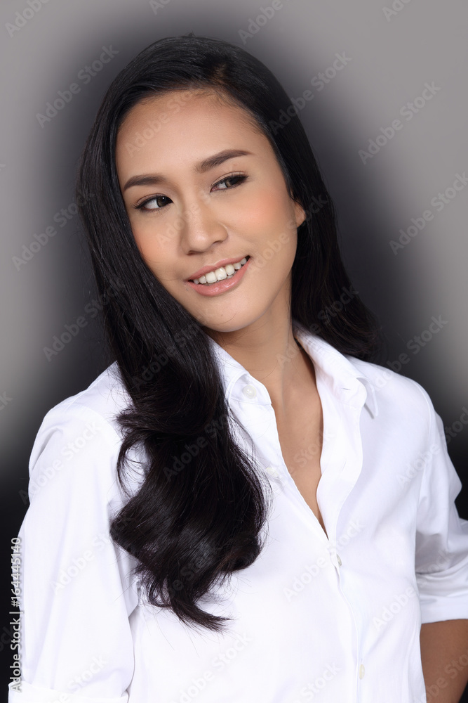 Smile with Teeth, Korea Girl black hair in white t shirt, half body portrait in studio lighting black background, copy space for text and logo Smile with Teeth, Korea Girl black hair in white t shirt, half body portrait in studio lighting black background, copy space for text and logo