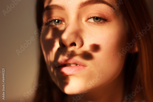 closeup fashion portriat of young model in sunset light