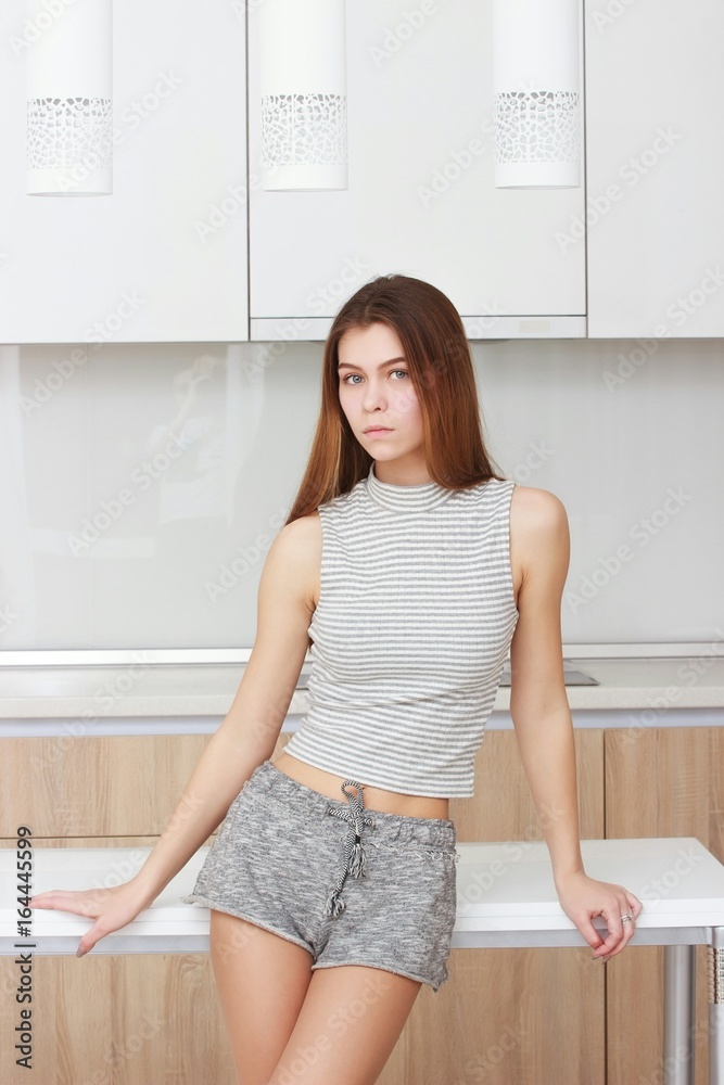fashion portrait of beautiful young girl posing in modern apartment fashion portrait of beautiful young girl posing in modern apartment