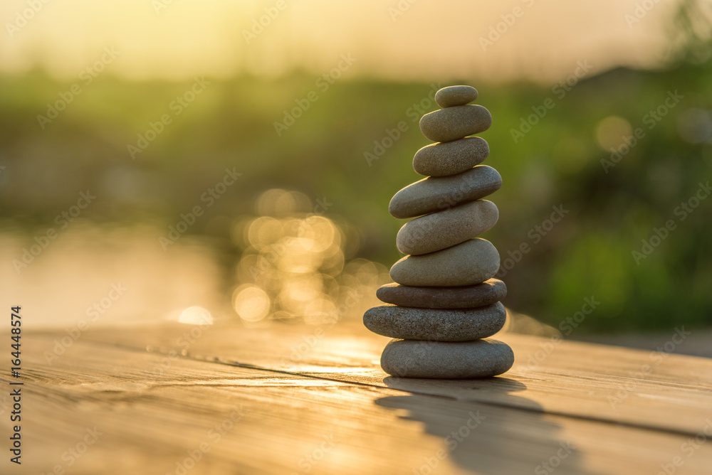 Obraz premium Zen Balancing Pebbles Next to a Misty Lake