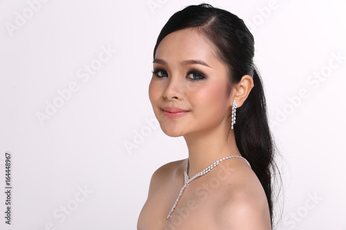 Asia Girl with open shoulder curl black hair, Diamond Necklace and diamond earring, copy space white background