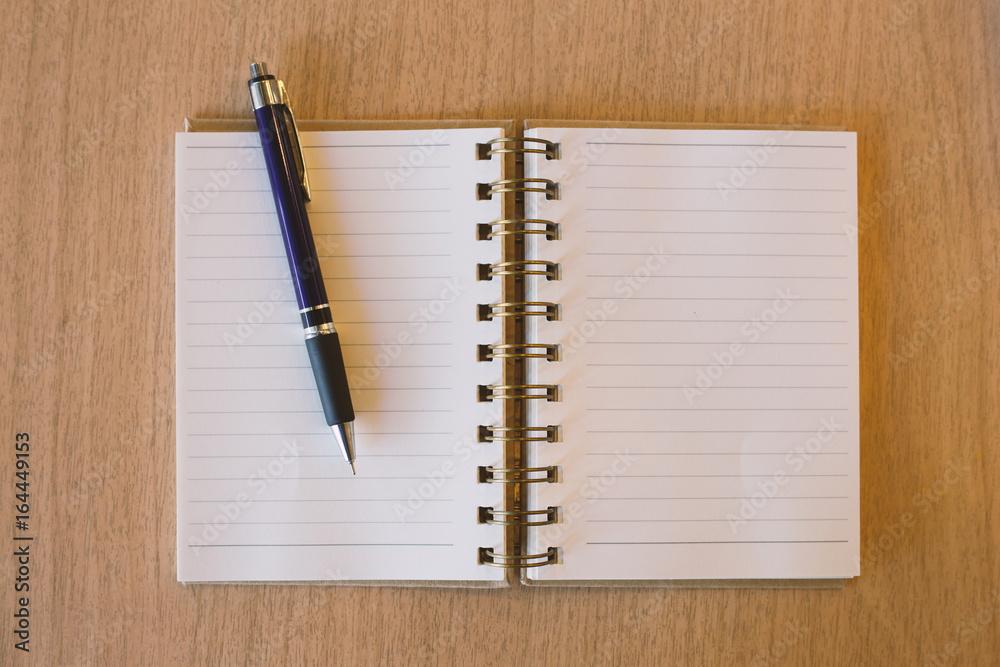 Blank notebook with pen on wooden desk Blank notebook with pen on wooden desk