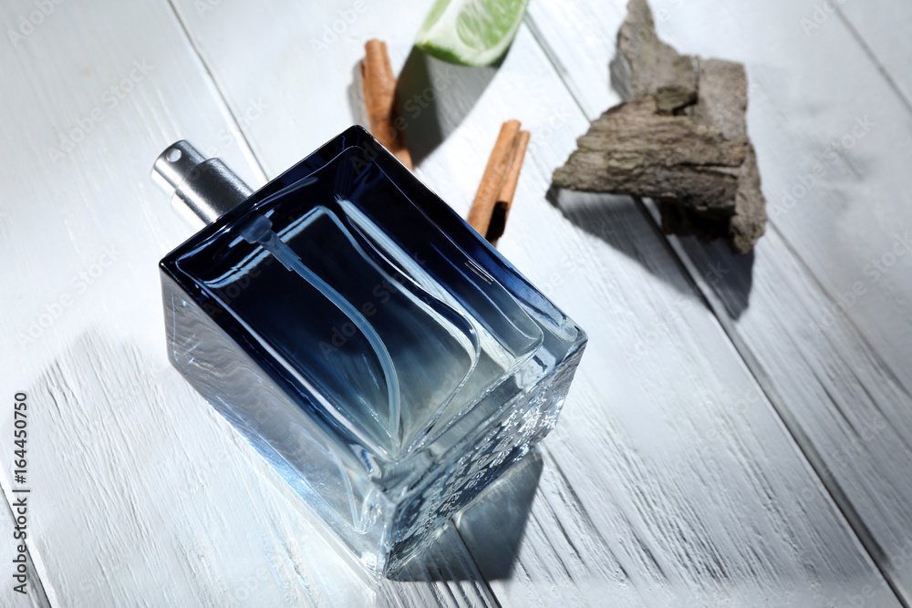 Composition with modern male perfume on wooden background Composition with modern male perfume on wooden background