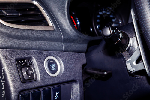 start engine button on the panel near the steering in modern car © vladimircaribb