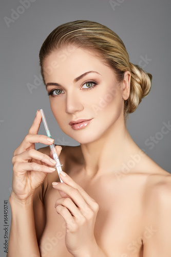 beautiful girl holding syringe