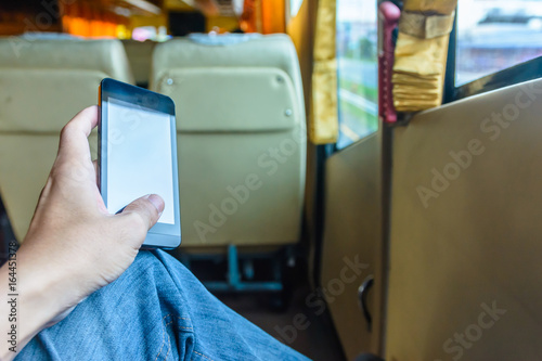 Concept and idea passenger play smartphone during travel trip on the way with bus in Thailand photo