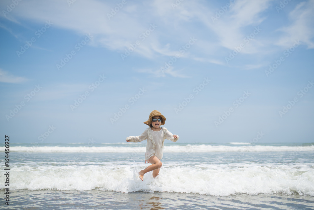 Happy little girl playing on the beach Happy little girl playing on the beach